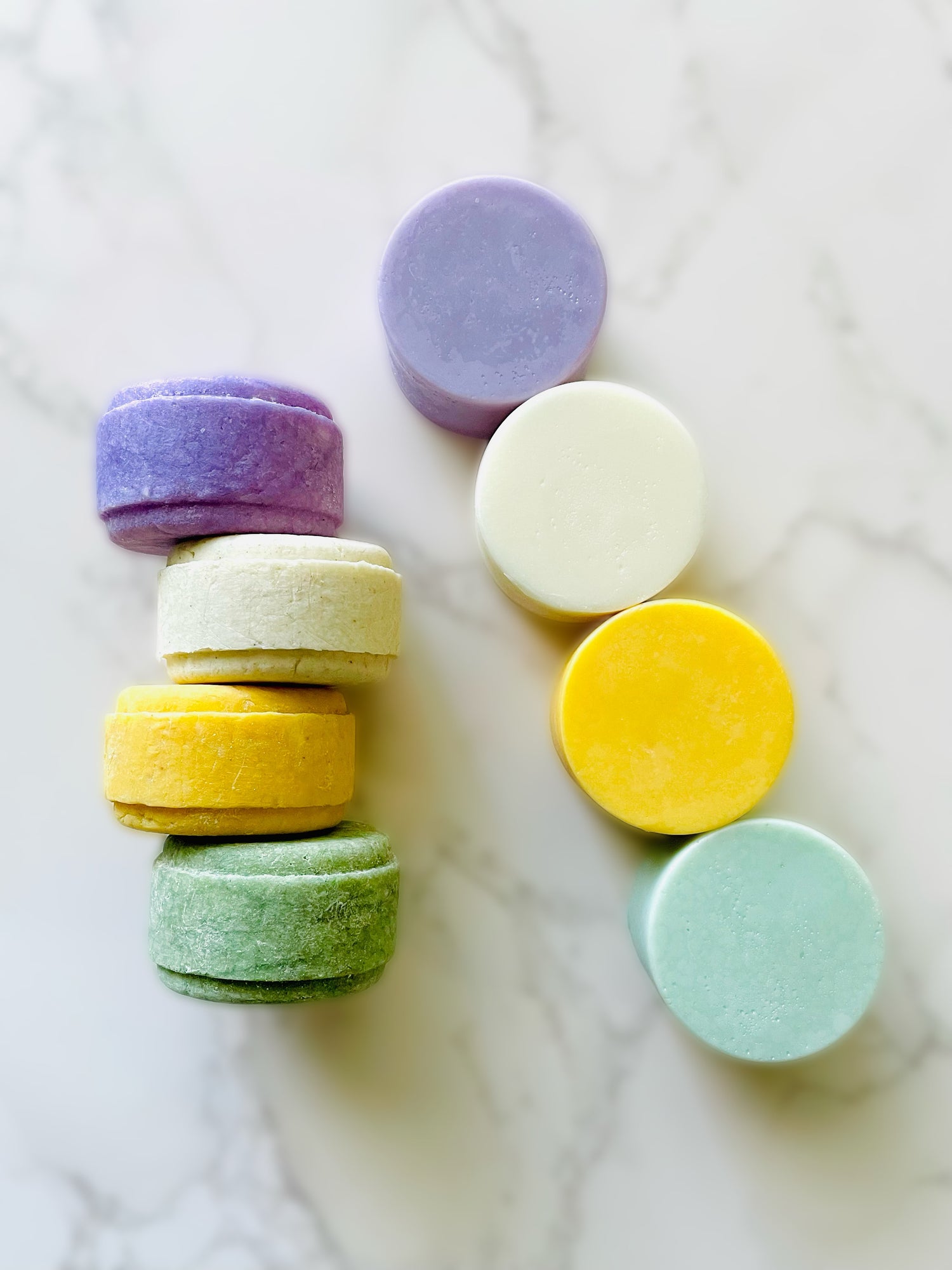 Four solid shampoo bars on the left and four solid conditioner bars on the right.