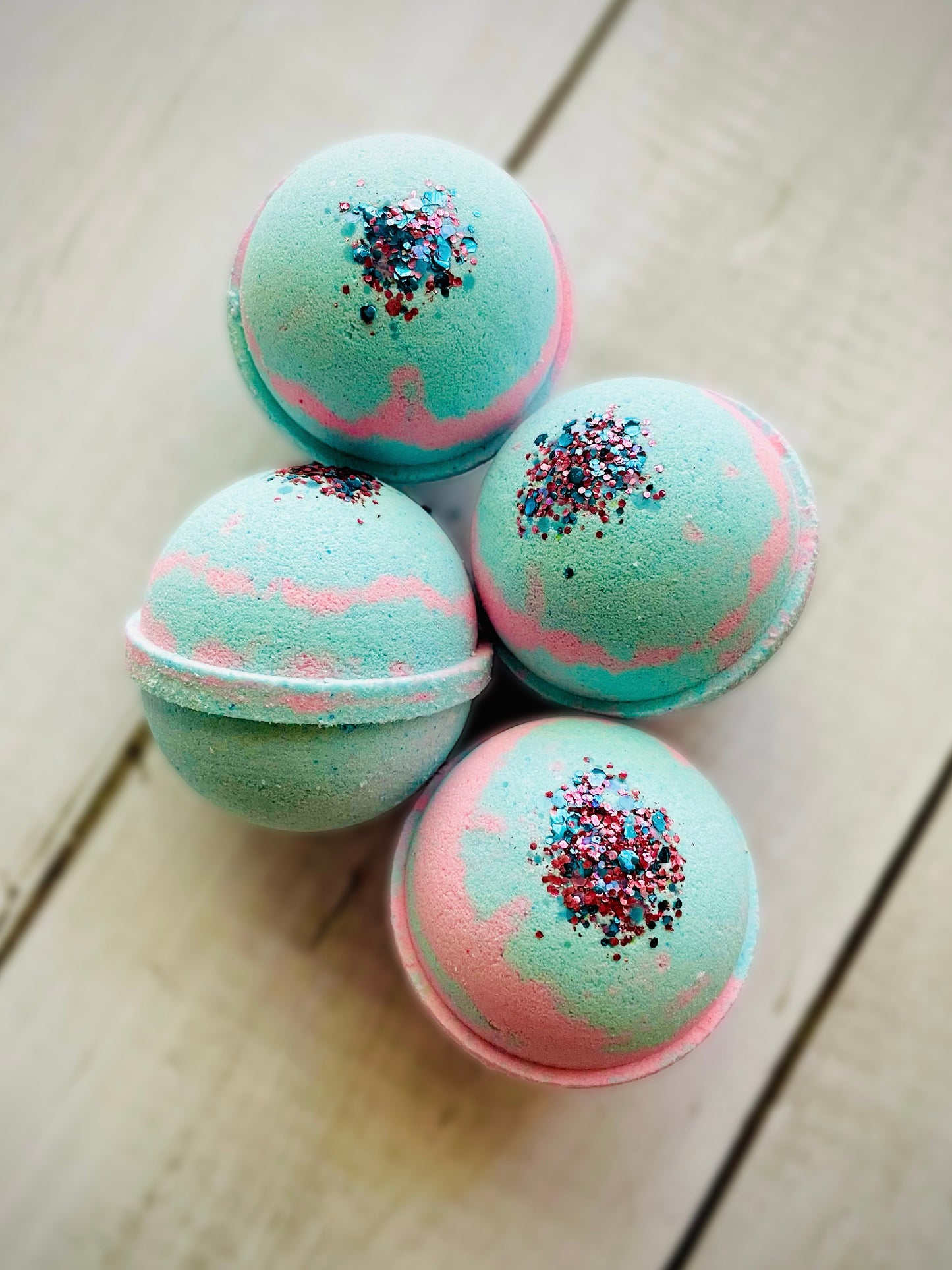 Four bath bombs with a Saturn ring.