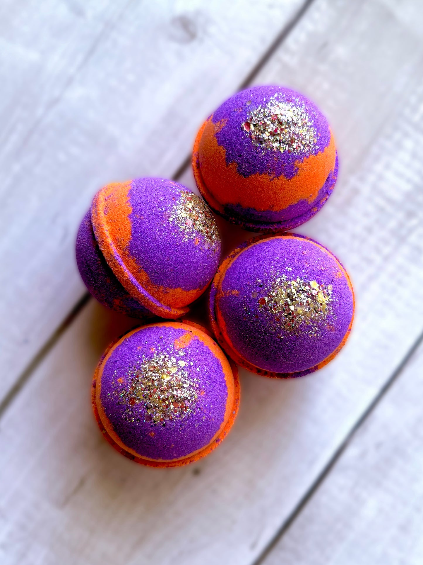 Four bath bombs with a Saturn ring.