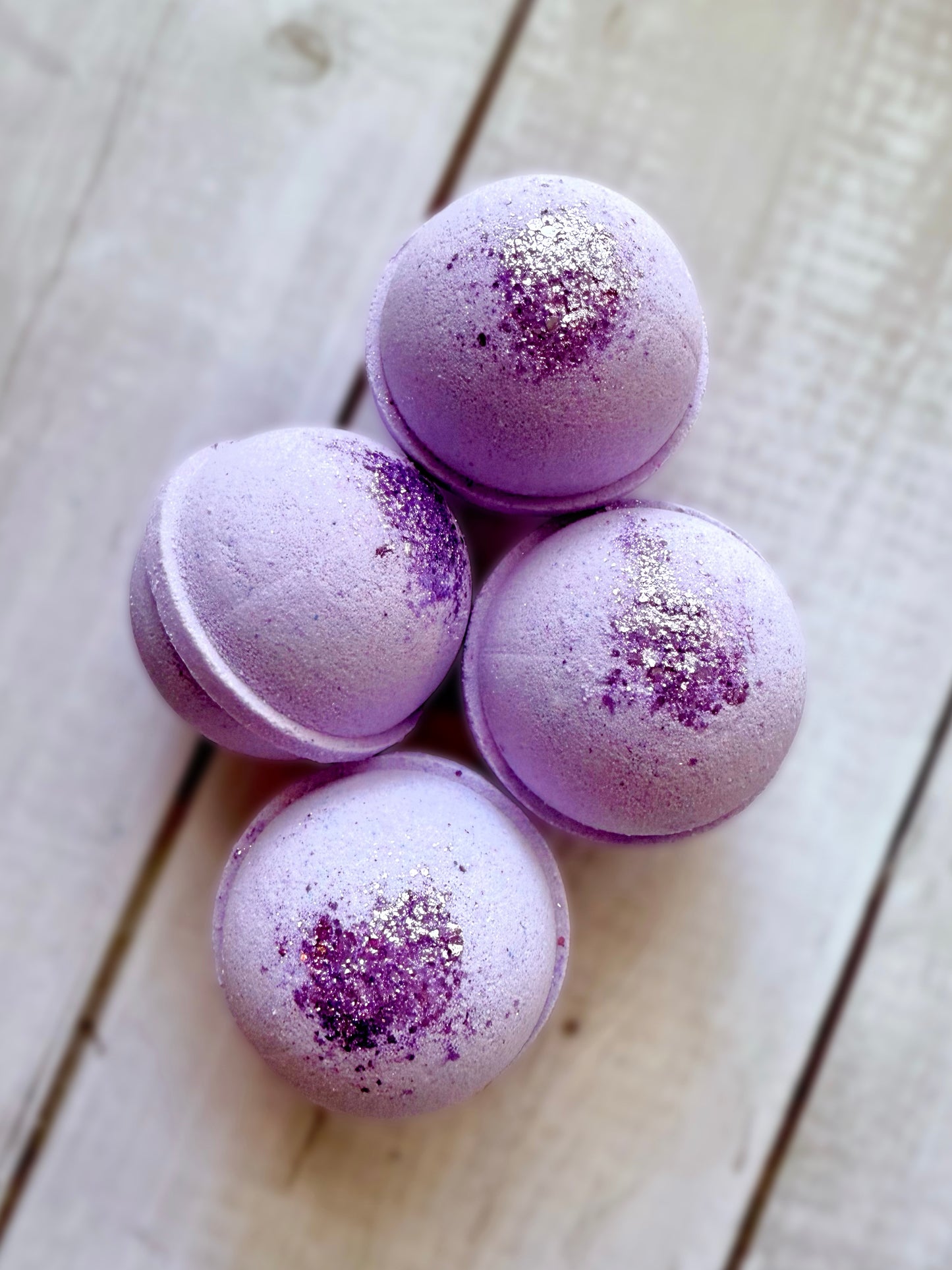 Four bath bombs with a Saturn ring.