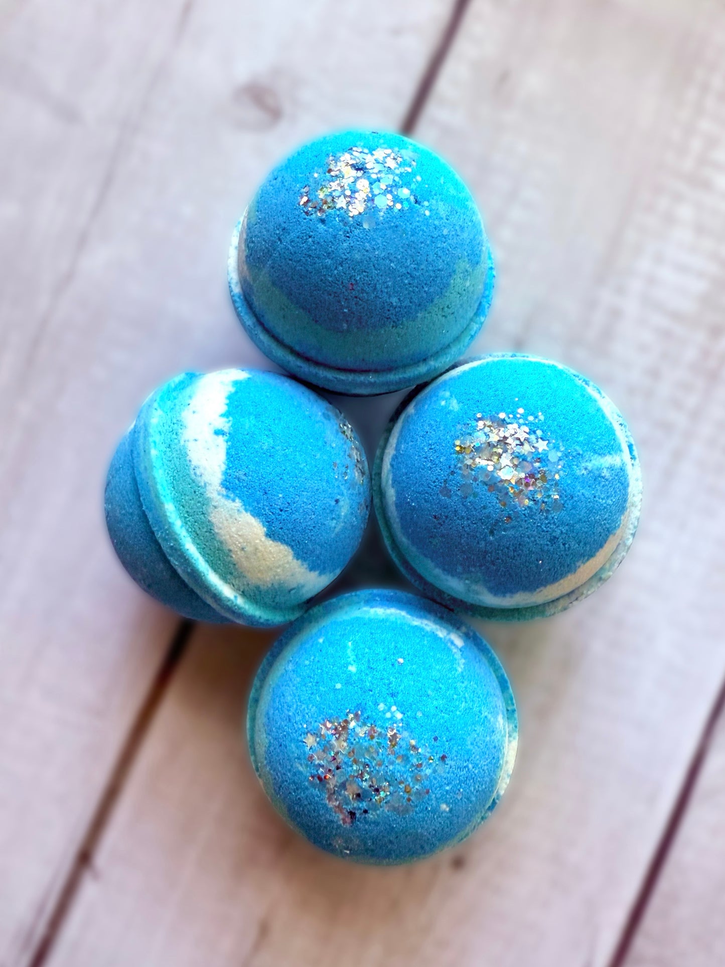 Four bath bombs with a Saturn ring.