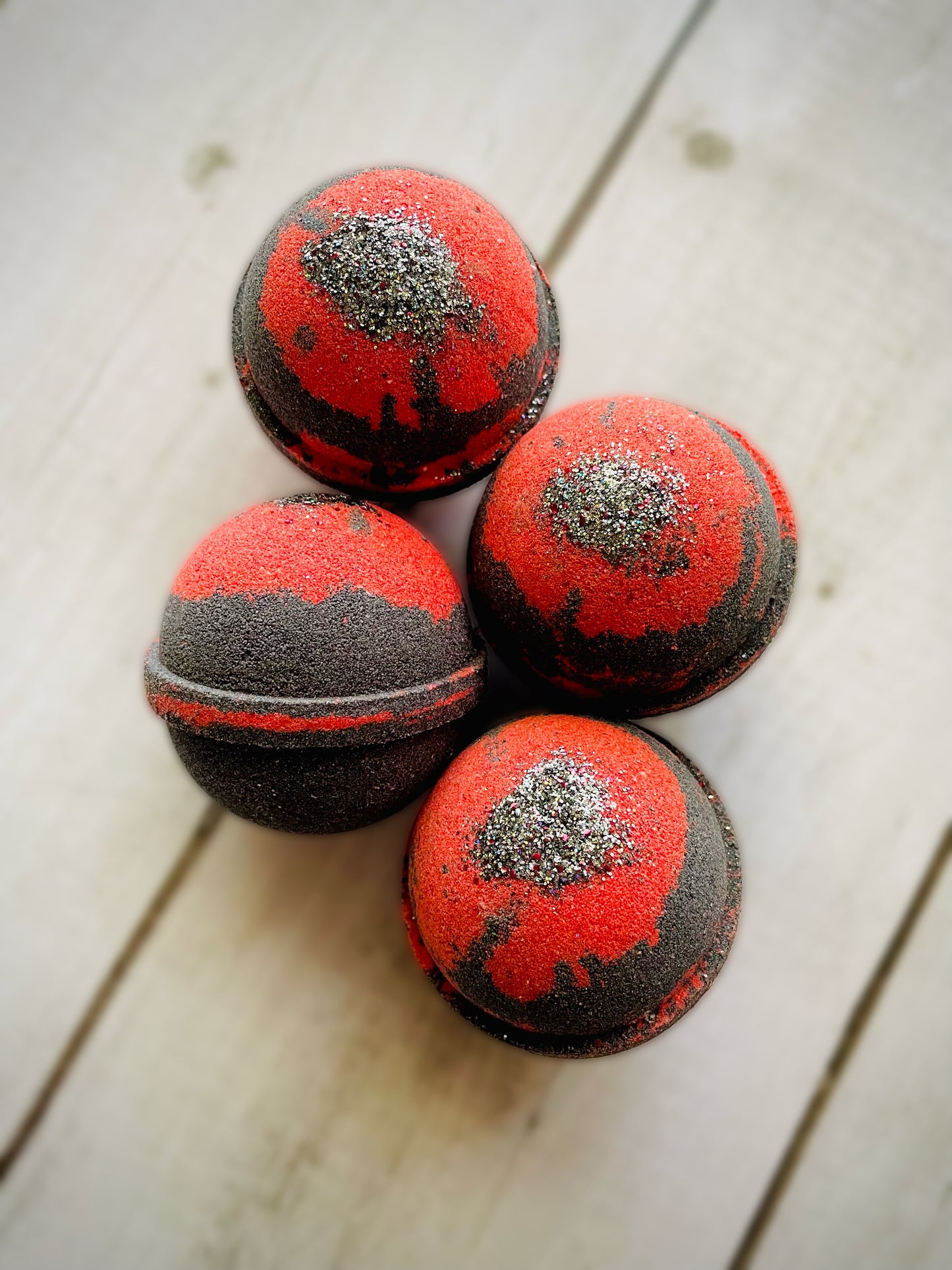 Four bath bombs with a Saturn ring.