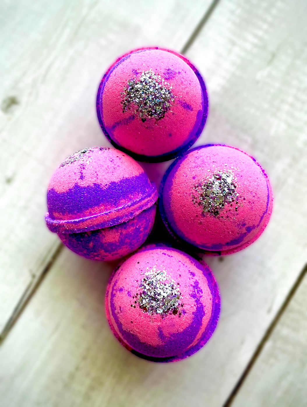 Four bath bombs with a Saturn ring.