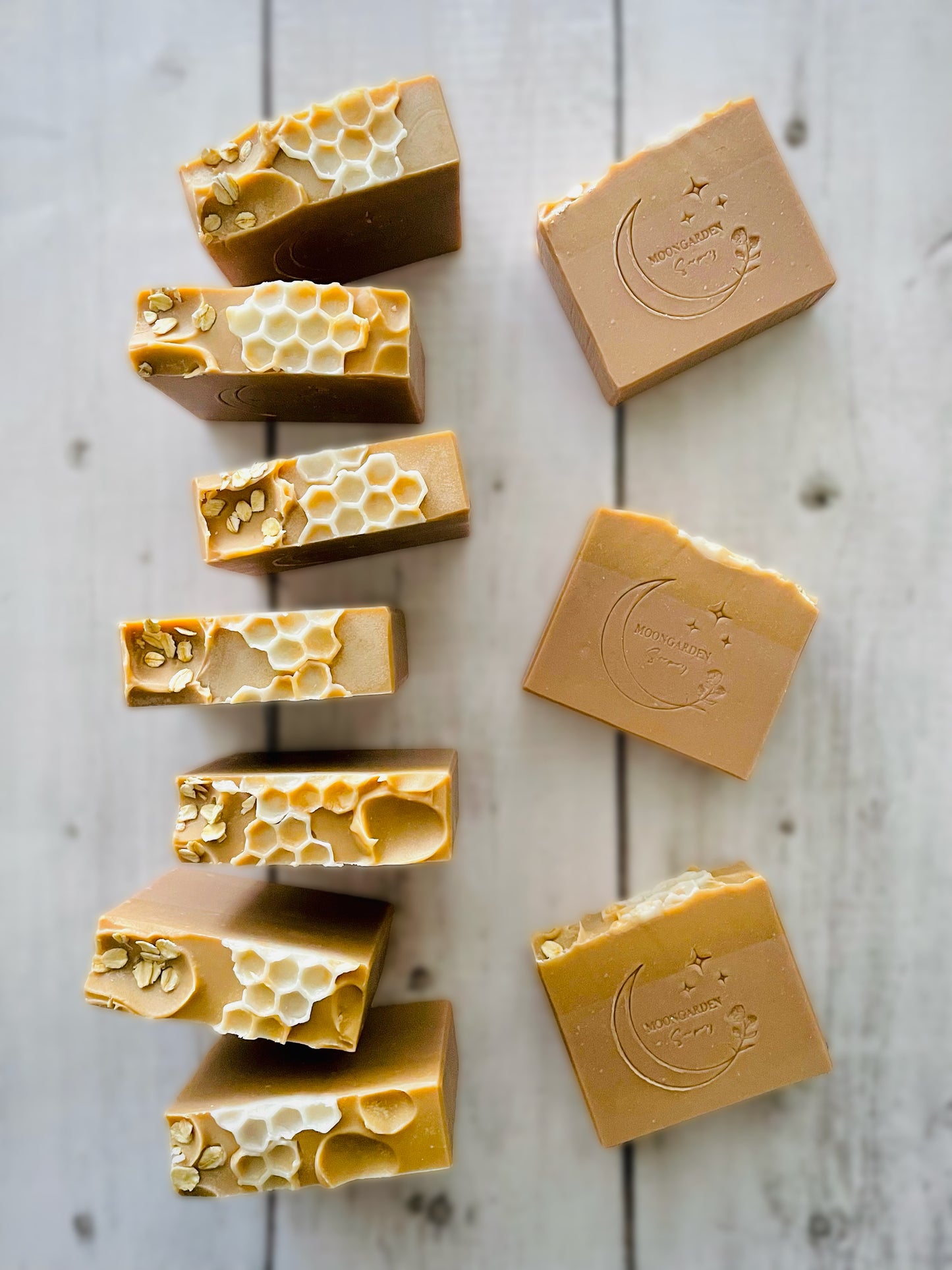 Ten bars of handmade soap with a honeycomb soap embed on top.