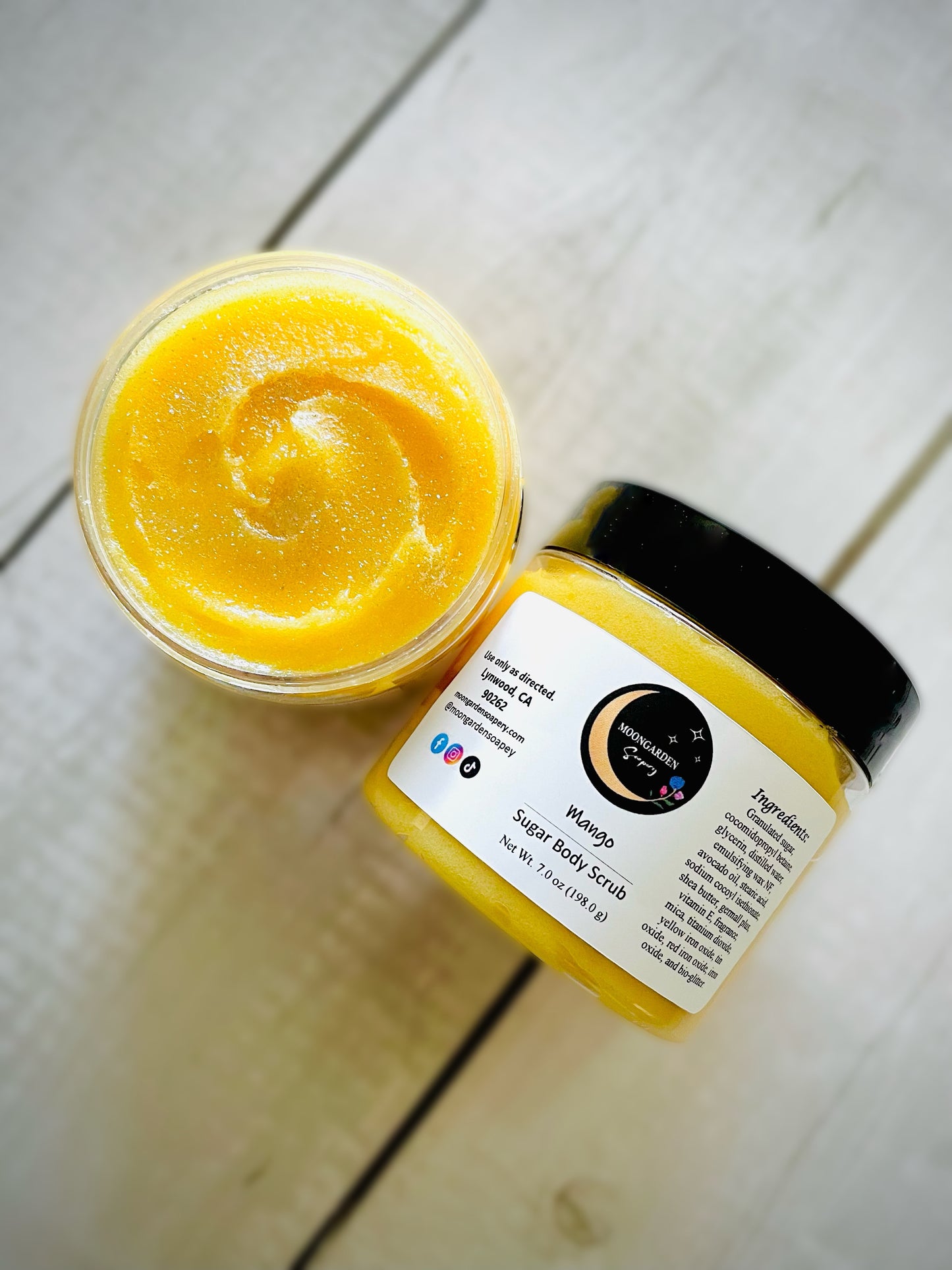 Two jars of mango sugar scrubs.
