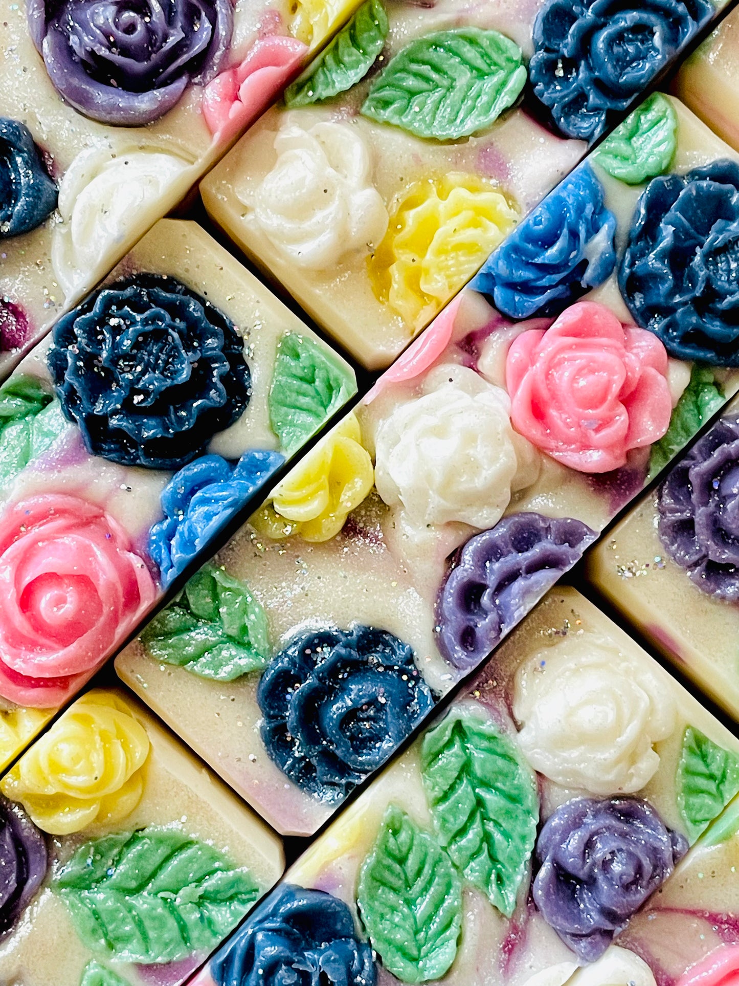 A closeup of the tops of Mrs. Oleson bar soaps. All soaps have flower soap dough embeds on top. 