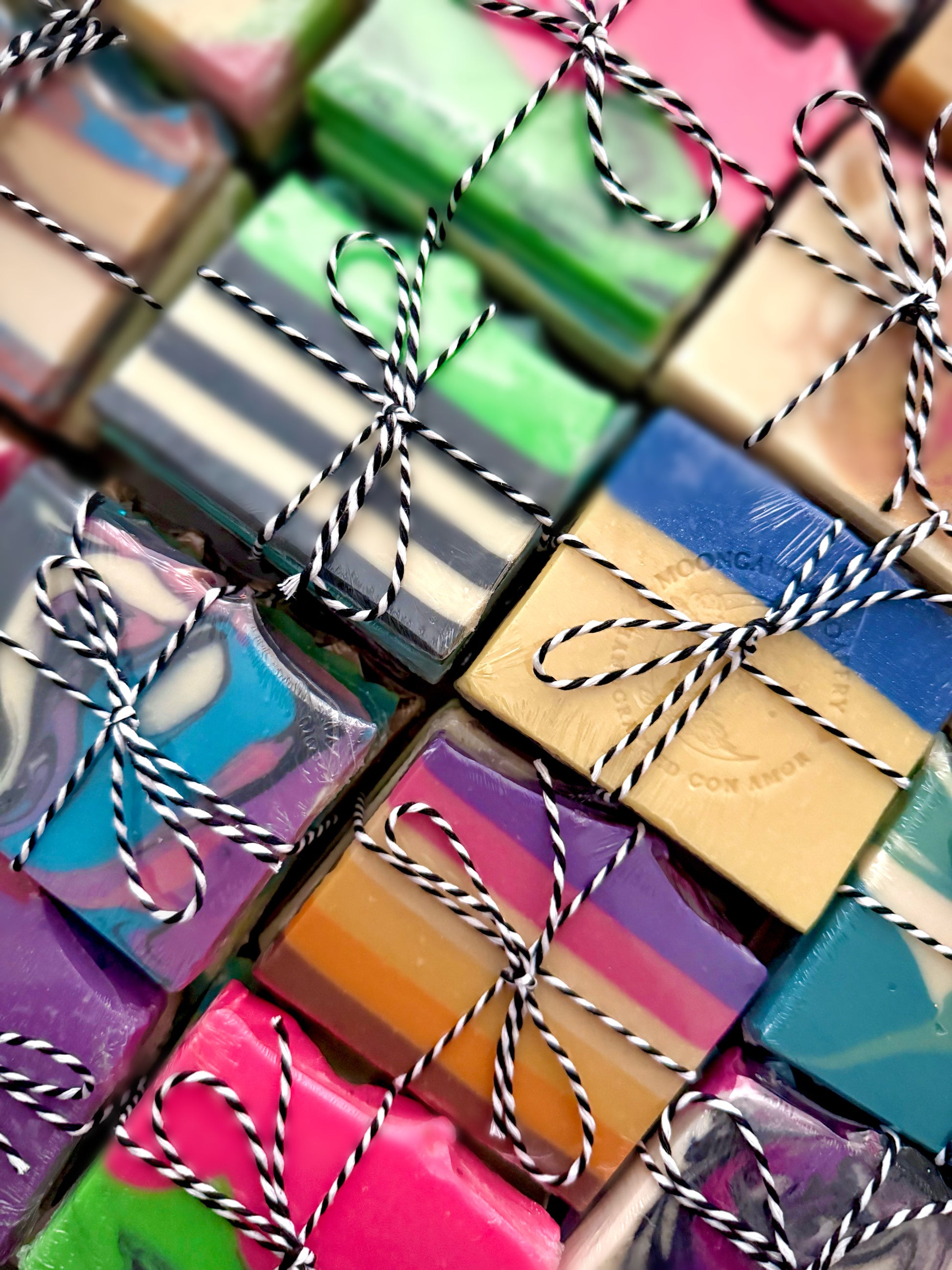 A close-up of various sample soap stacks each tied with a twine string. 