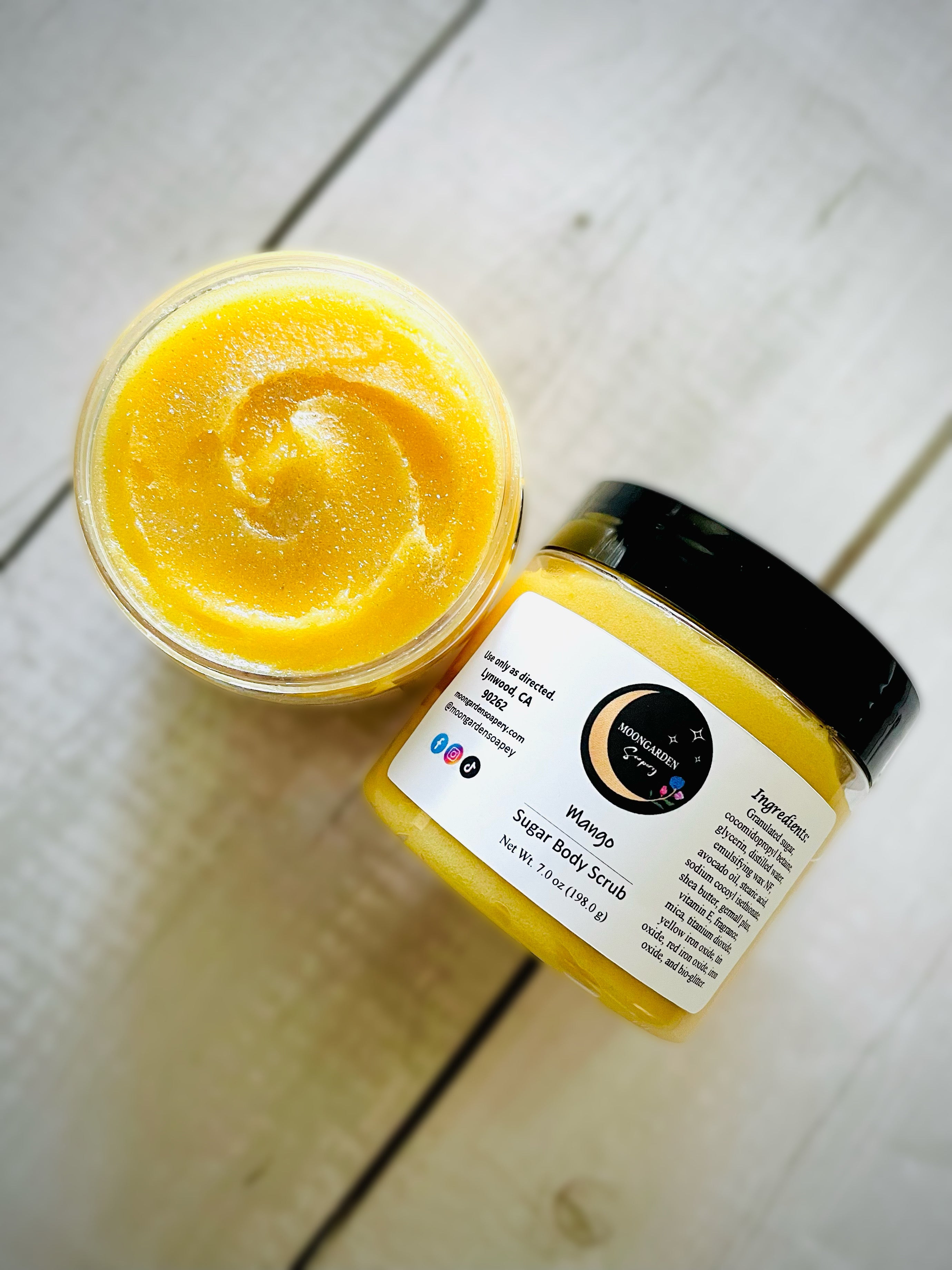 Two jars of mango sugar scrubs.