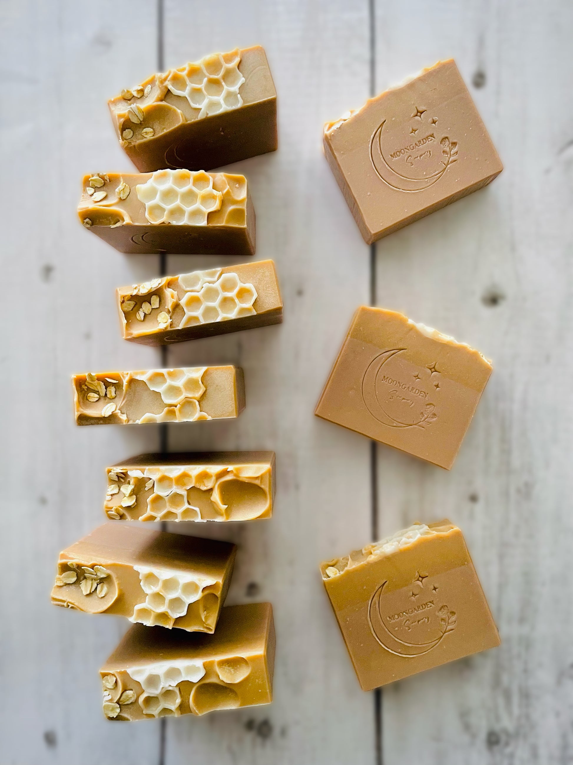 Ten bars of handmade soap with a honeycomb soap embed on top. 