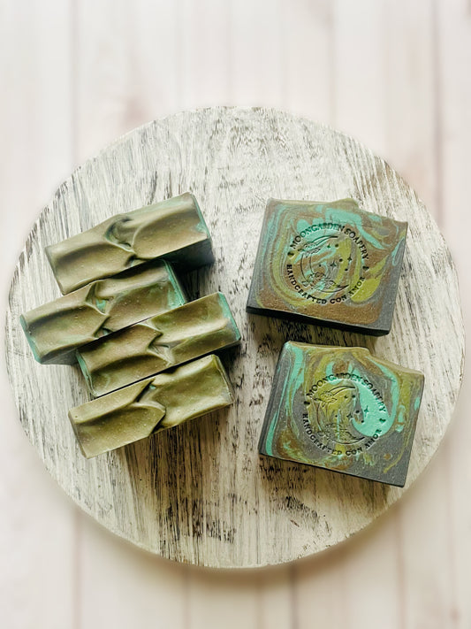 Six bars of soap on top of a wooden serving tray. 