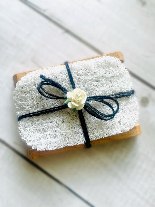 One soap dish with soap saver pad tied with black twine string and adorned with a paper rose on top. ￼