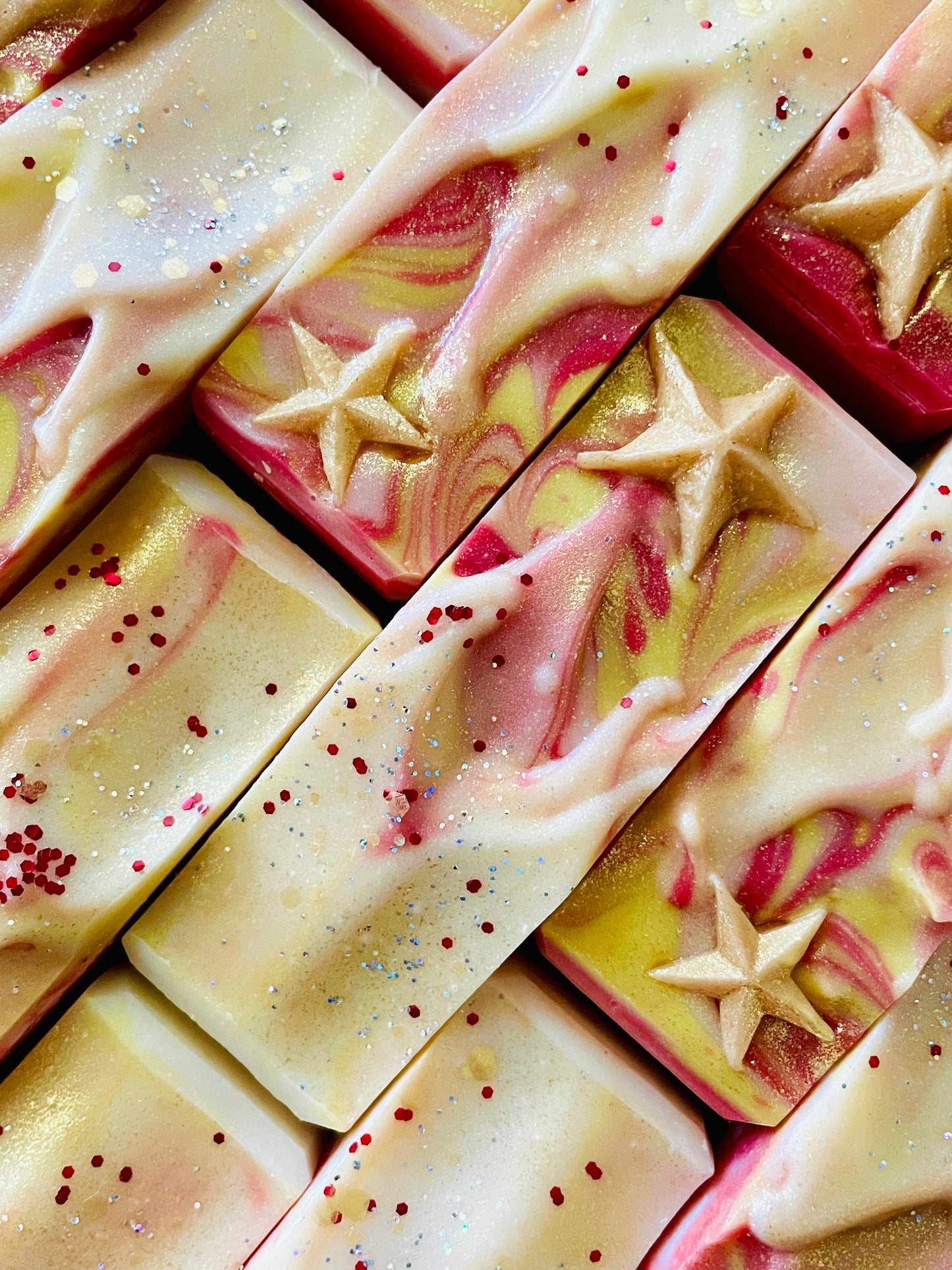 A closeup of the tops of Supernova bar soaps. Each bar has star soap dough embed on top.