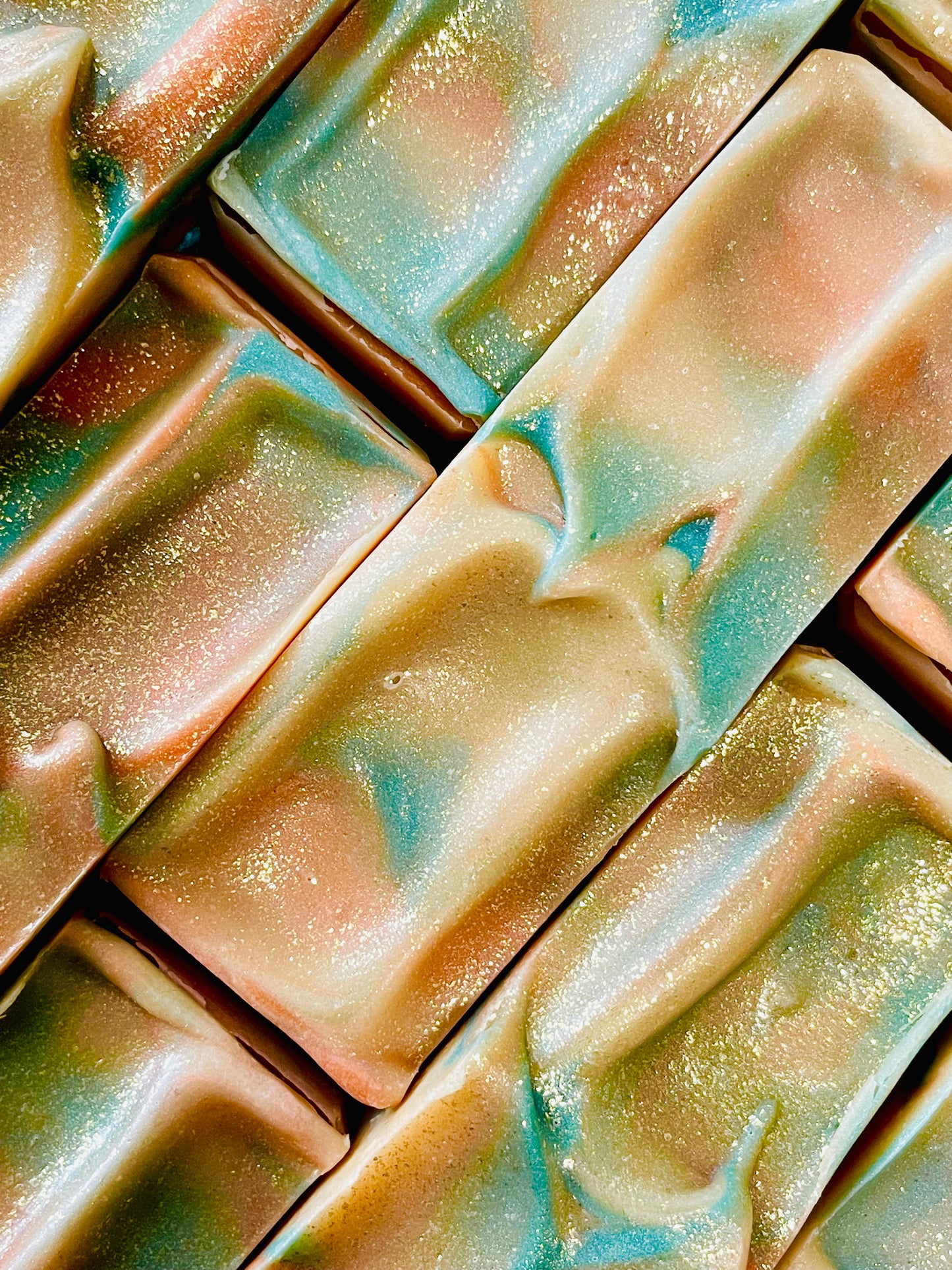 A closeup of the tops of Pure Energy oakmoss and amber bar soaps. 