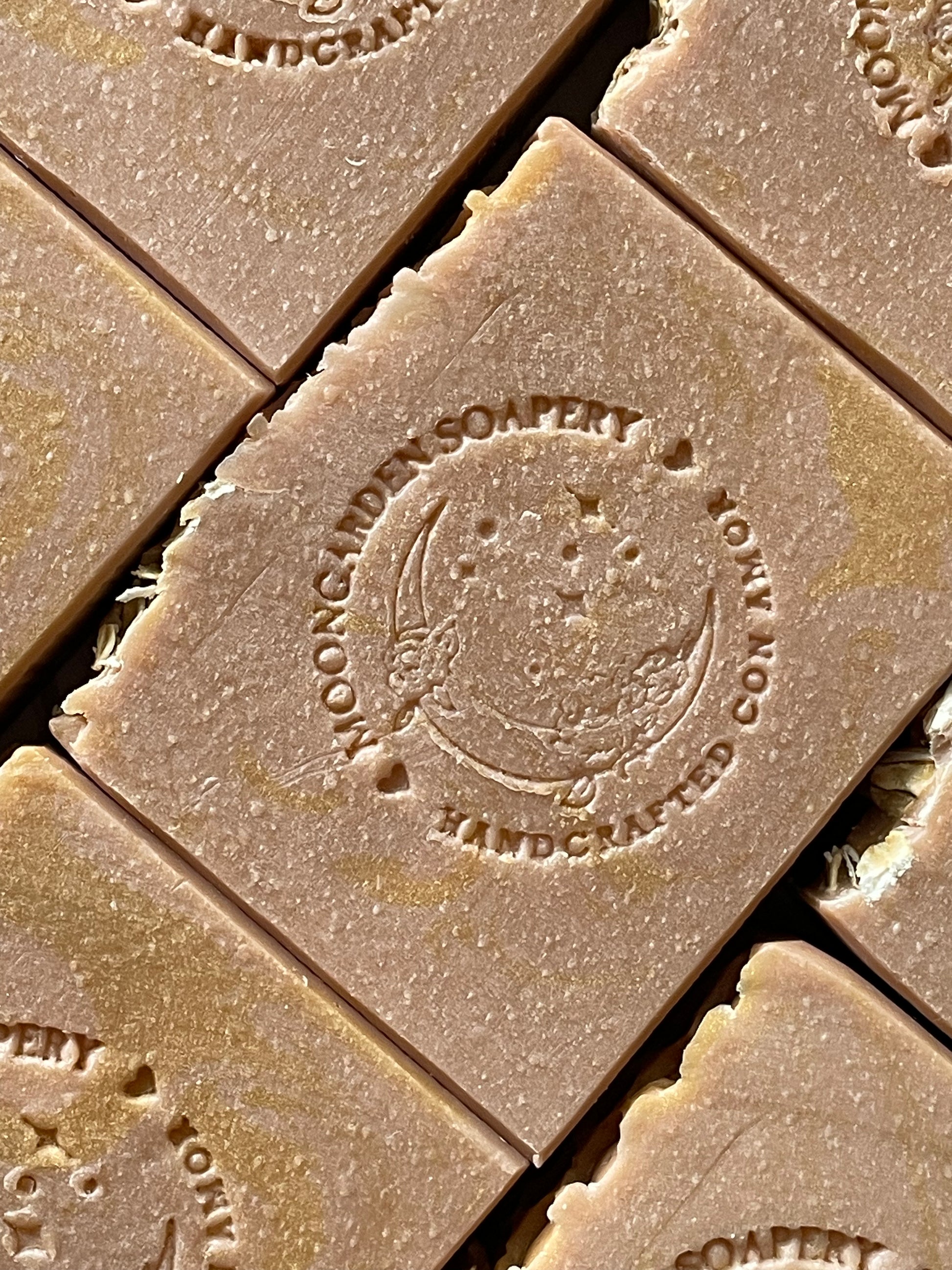 A closeup of the front face of Hall and Oats oatmeal, milk and honey bar soaps. 