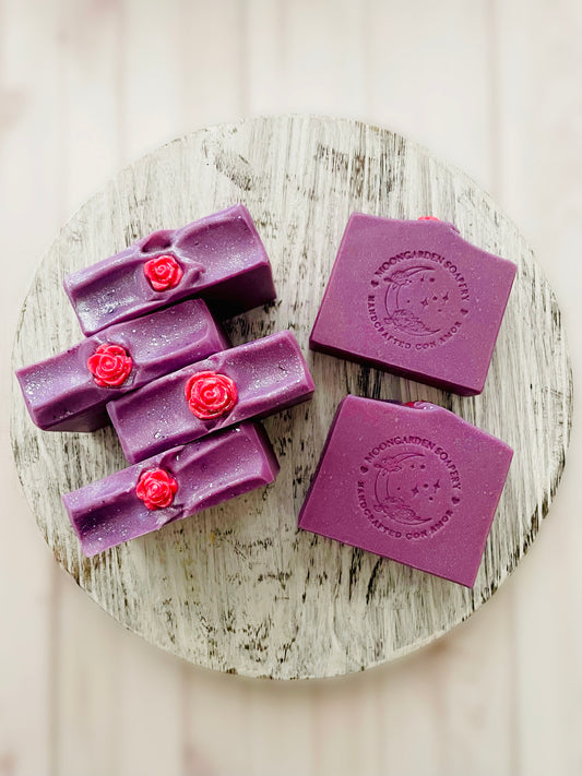 Six soap bars sitting on a round wooden serving tray. 