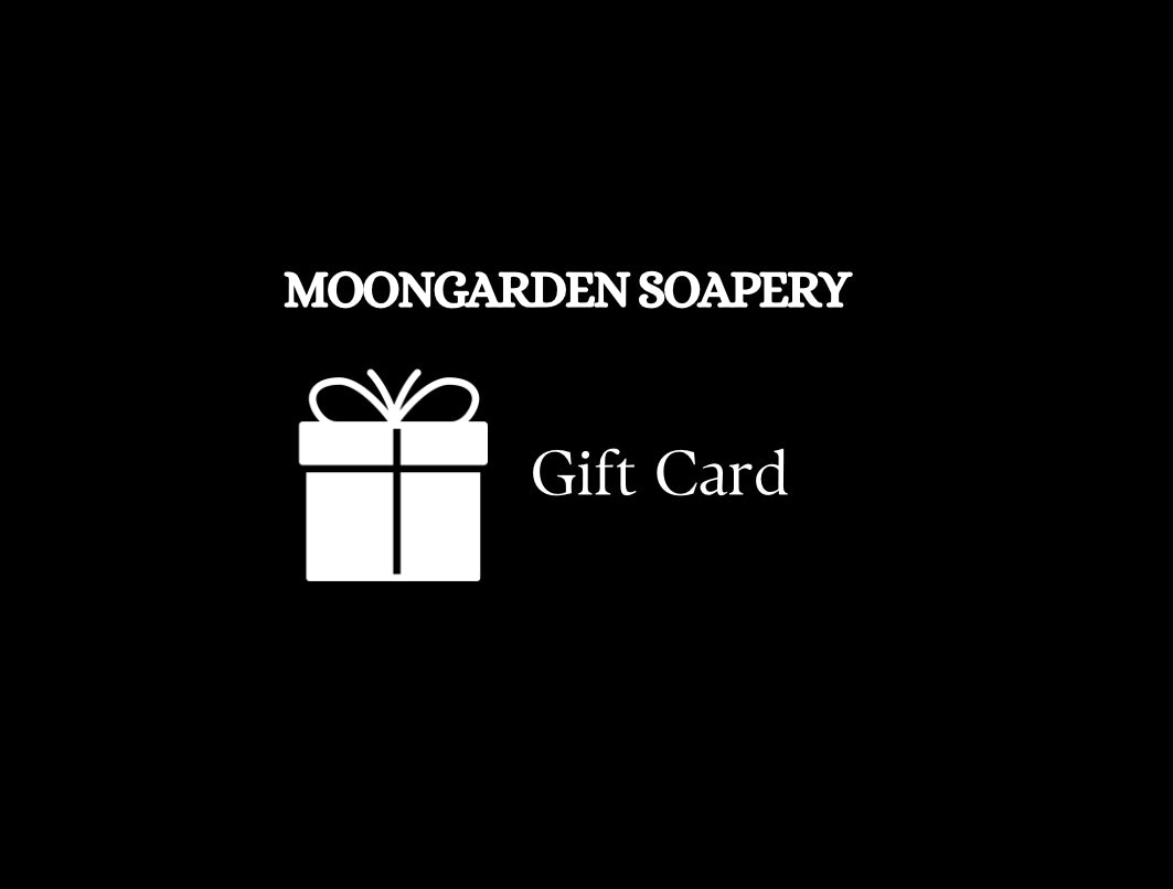 Gift card announcement. Business name, Moongarden Soapery, on top with gift box below and the words Gift Card on the right. 